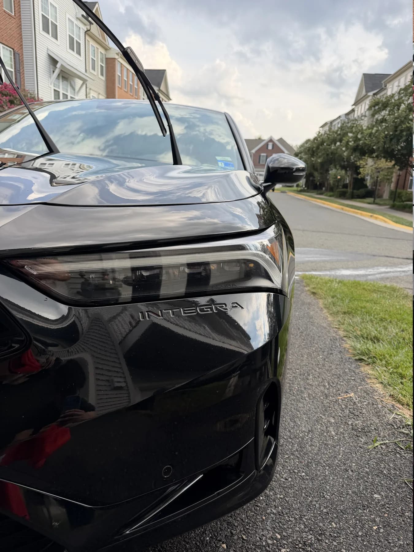 Close view of a black Acura Integra with a glossy detailed finish
