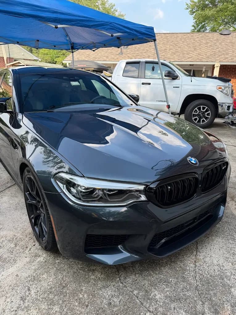 Dark gray BMW with a deep reflective finish after mobile detailing