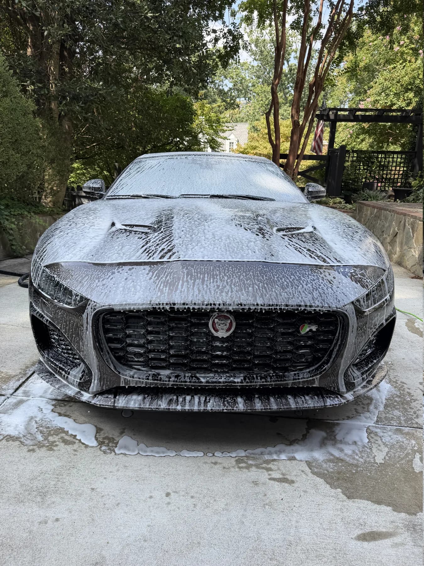 Jaguar covered in foam during a driveway exterior detail