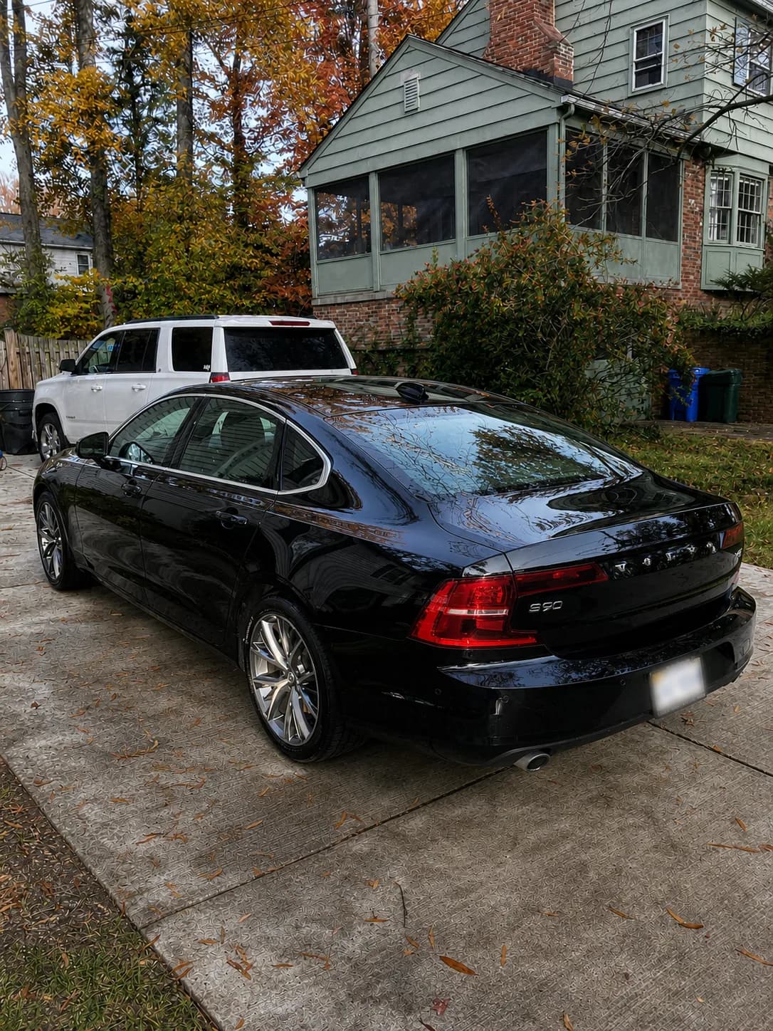 Black Volvo sedan with a glossy reflective exterior after detailing
