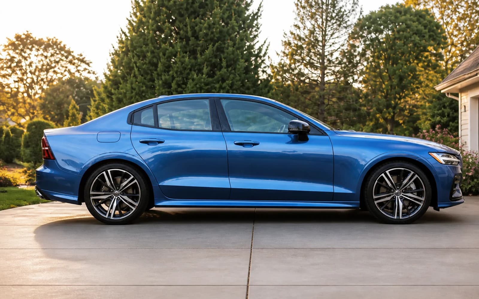 Freshly detailed blue luxury sedan shown in a clean side profile after a complete detail and ceramic coating